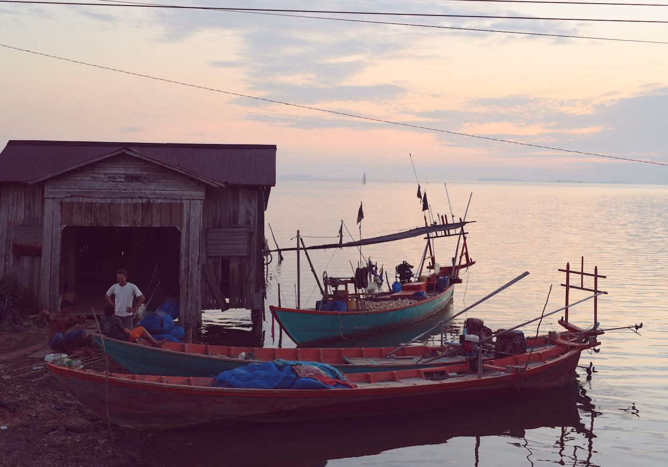 Cambodian fishermen relaxing at the end of the day