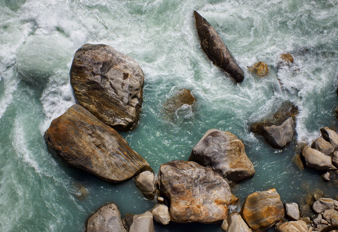 Overhead view of a rushing river and boulders